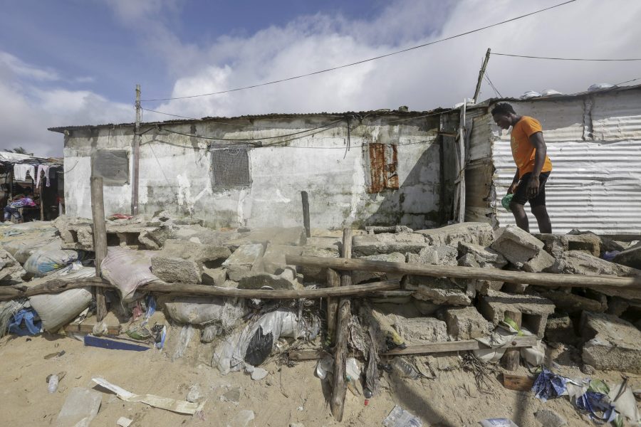 A Liberian man walks along a community built protection wall against sea erosion in West Point coastal slum community in Monrovia, Liberia October 23, 2021. EPA/AHMED JALLANZO